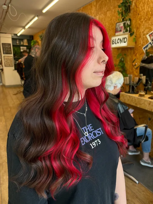 Cherry-red colour melt through dark hair
