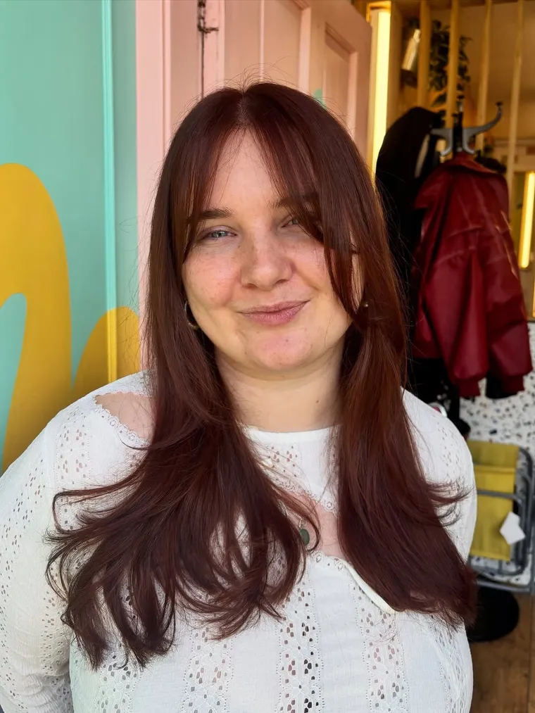Client with a rich copper-red restyle at HIVE Hair Salon